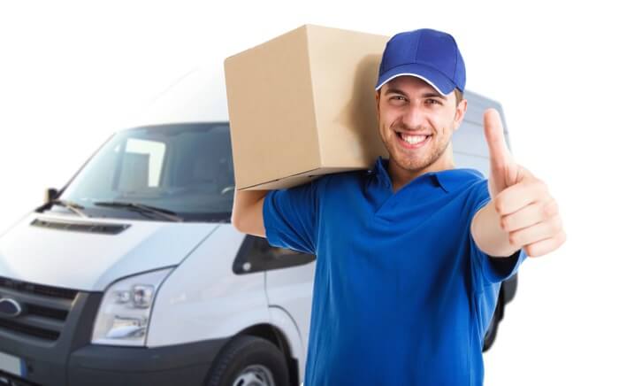 A delivery driver lifts a box