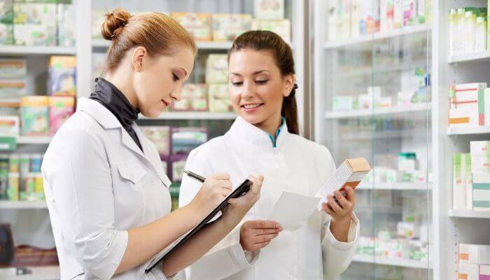 Two pharmacist working on a checklist. 