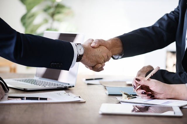 business person shaking hands on deal